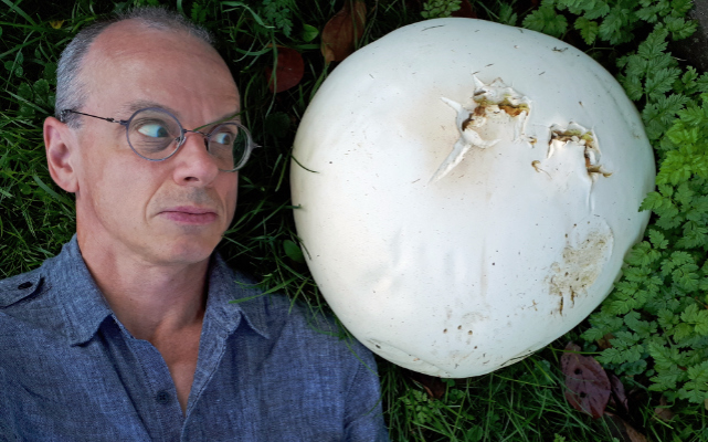 Portrait of James Schidlowsky with a large puffball mushroom